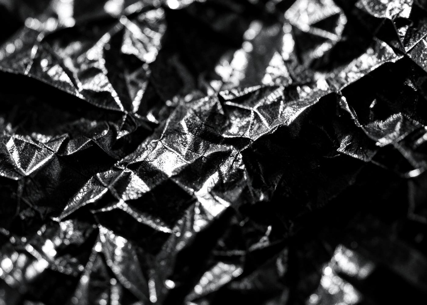 Macro texture of crumpled metallic black paper